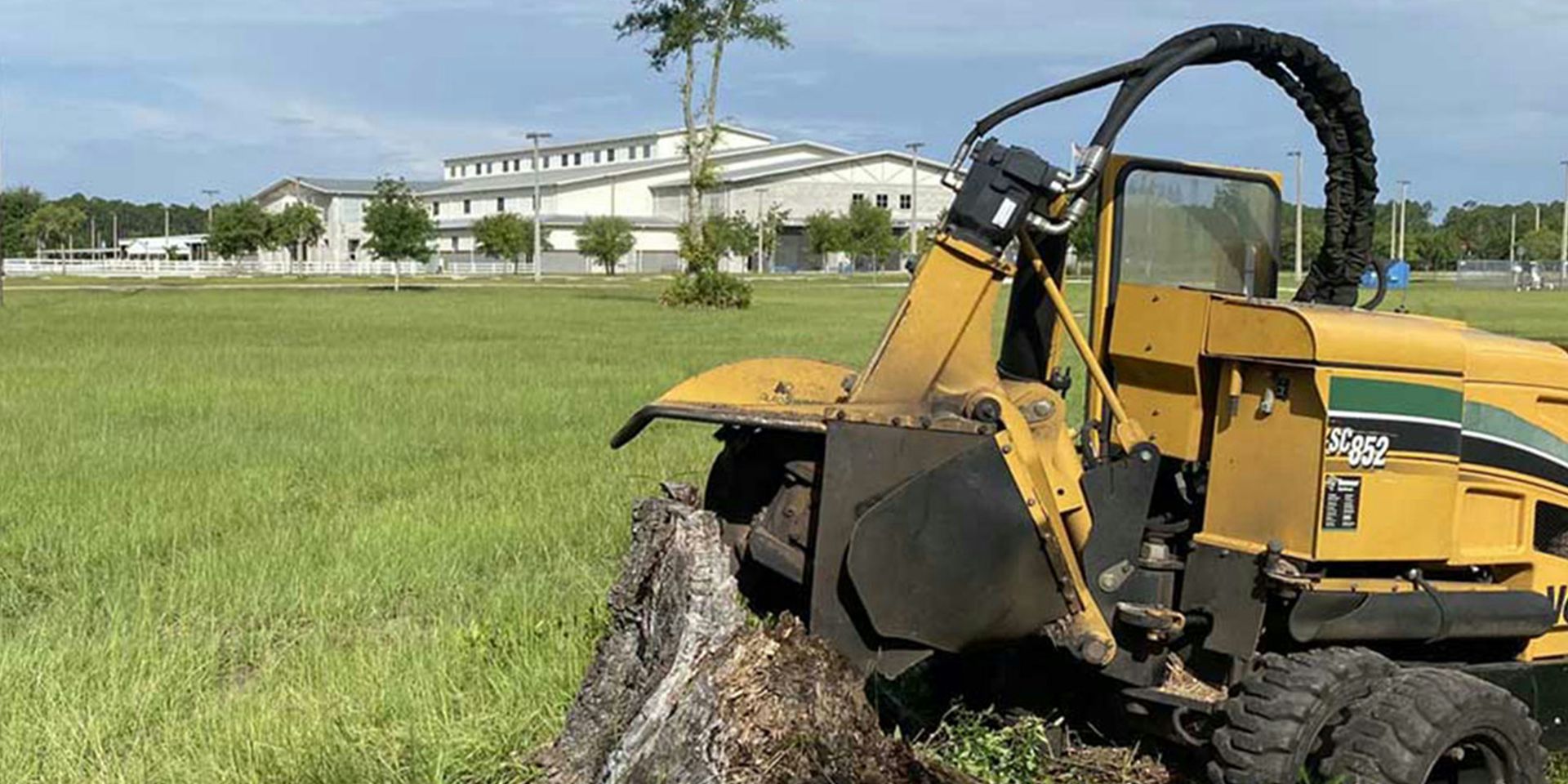 a tractor that is sitting in the grass